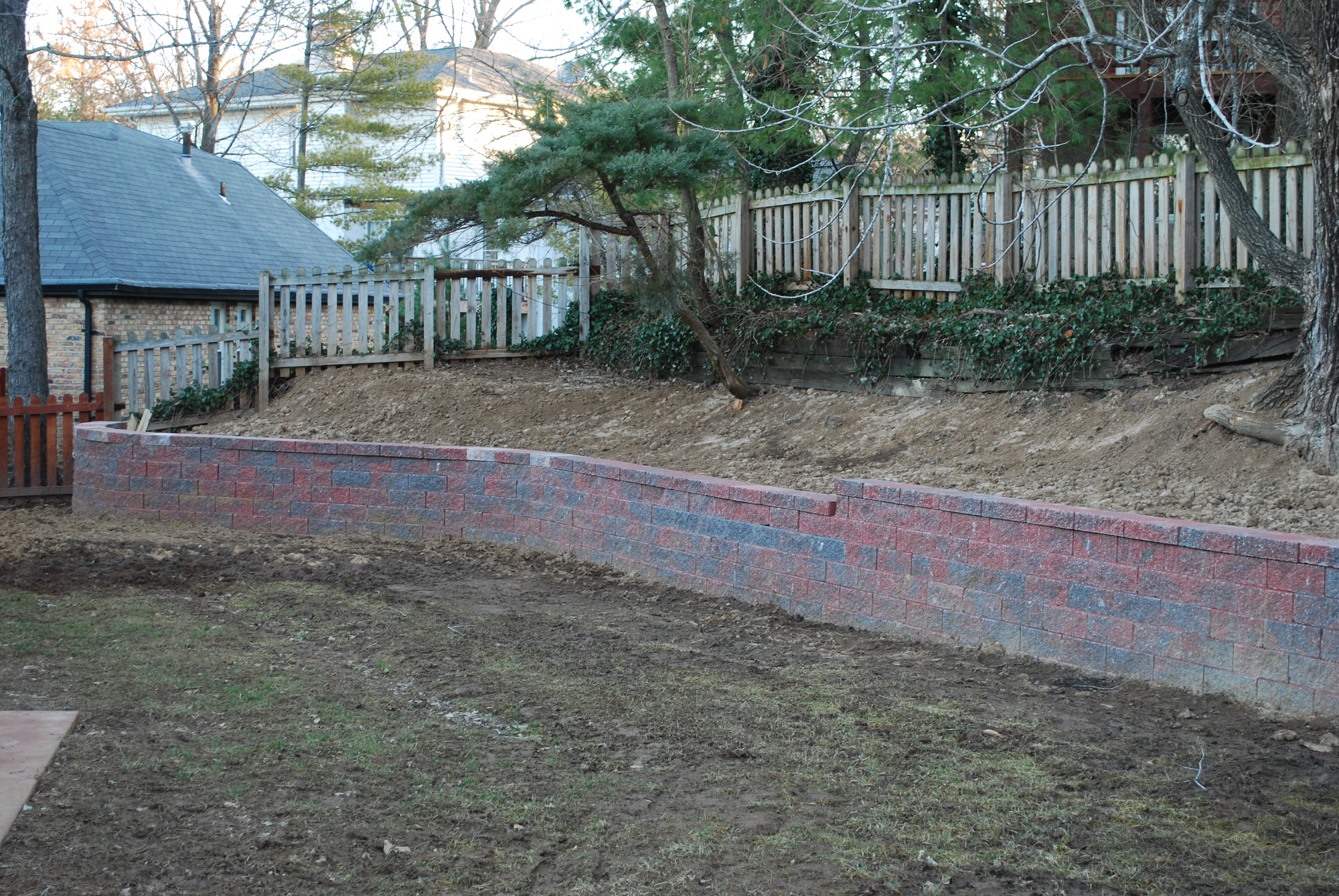 Retaining wall constructed with Versa-Lok block by Greenstone Landscaping in St. Louis County.