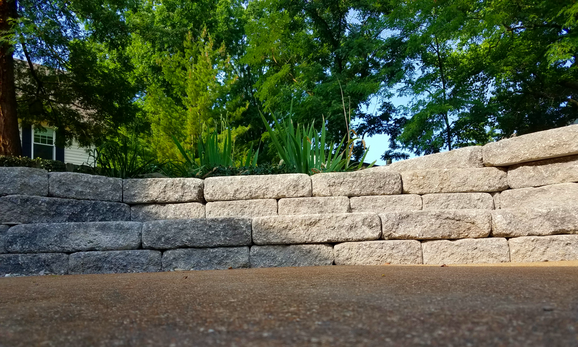 Finished steps made of retaining wall blocks connecting upper and lower patios by Greenstone Landscaping in St. Louis County.